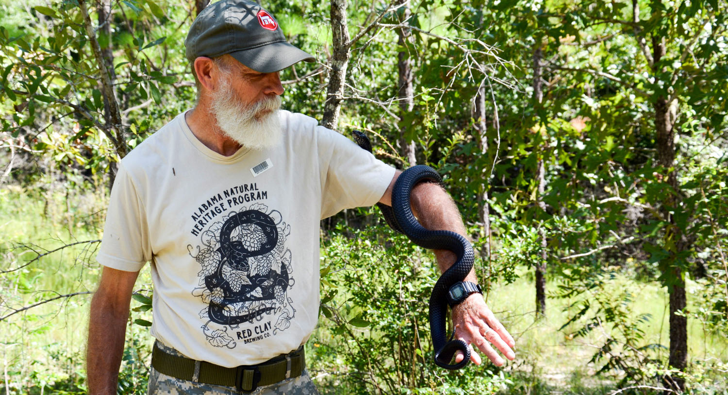 James Godwin holding an indigo snake