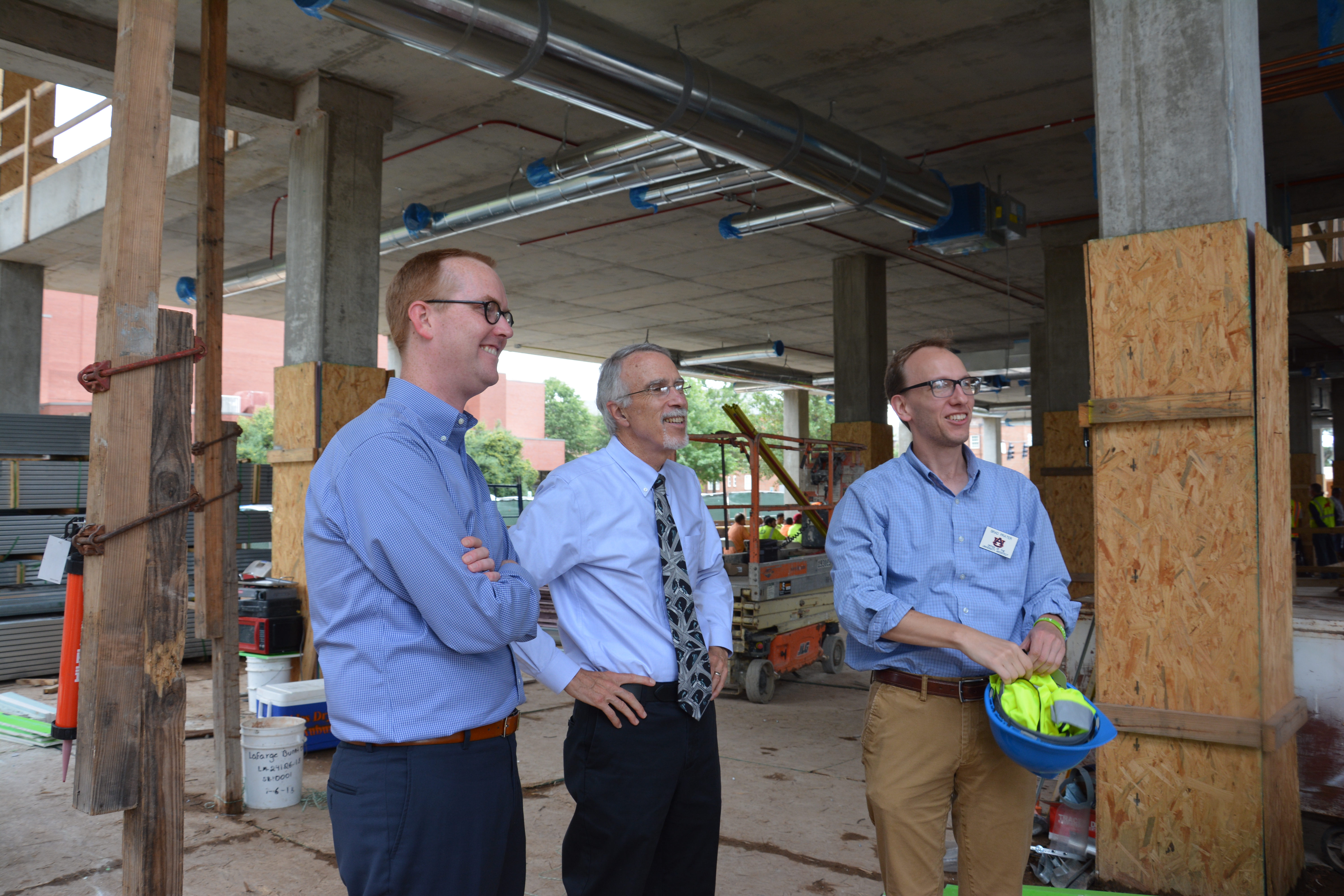 Three AU staff looking at the new Leach Sciences Center.