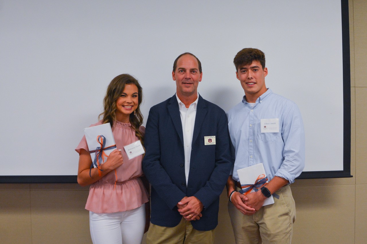 Clay Harper and two Auburn students receiving scholarships