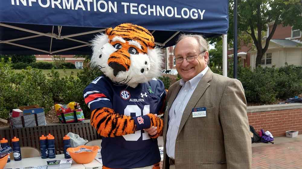 Auburn Chief Information Security Officer with Aubie on the quad.