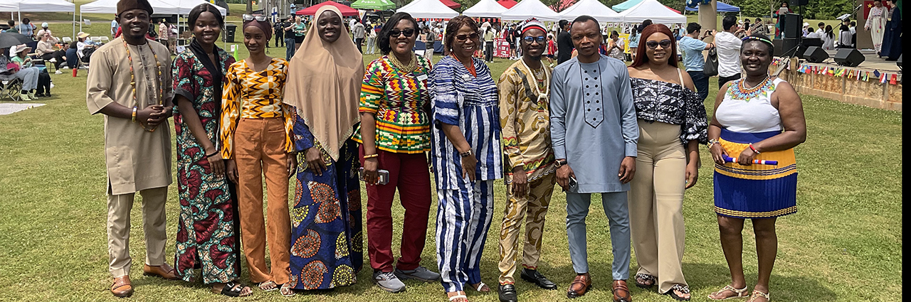Group of men and women dressed in African cultural attire.