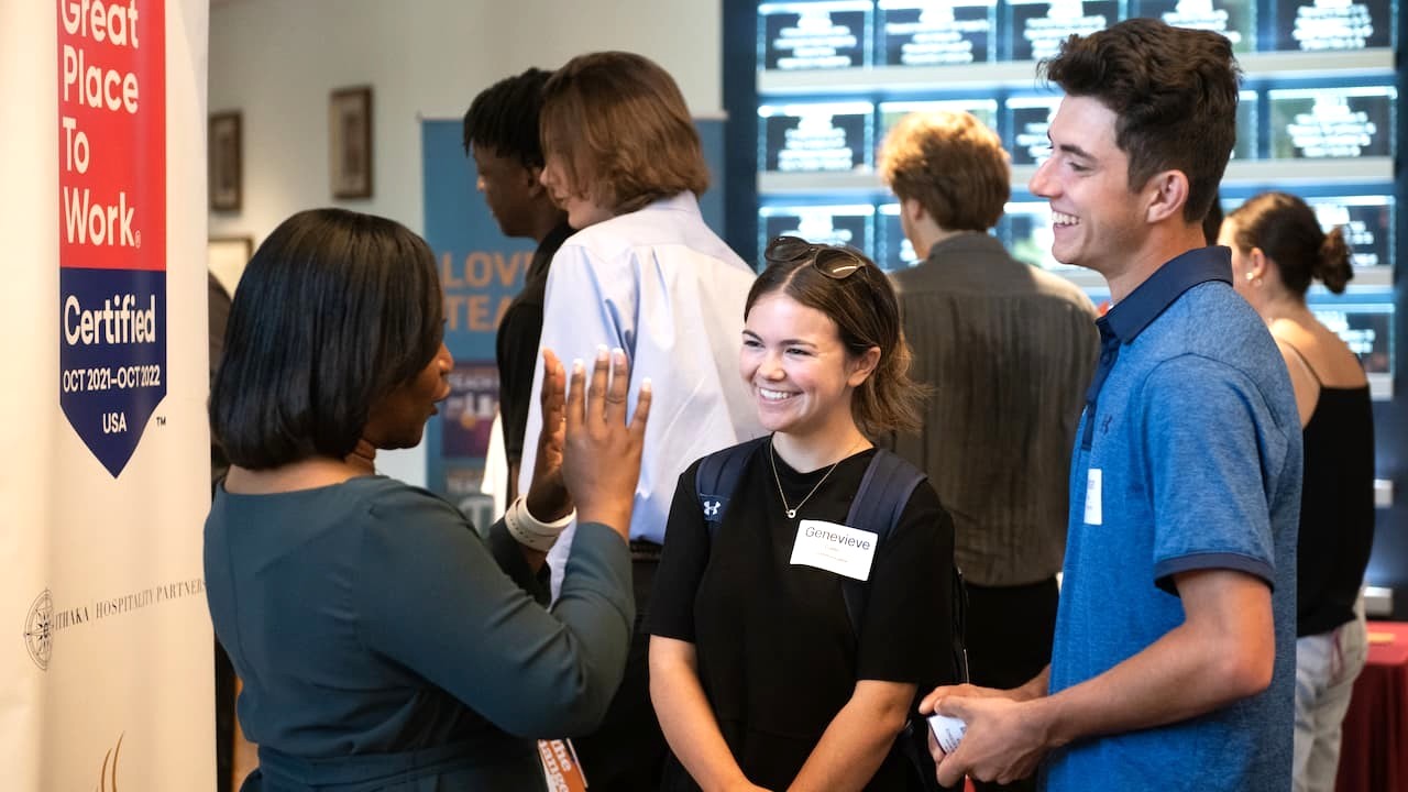 two students talking to a recruiter at a job fair