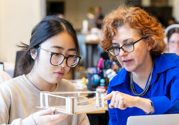 A student works with a mechanical press