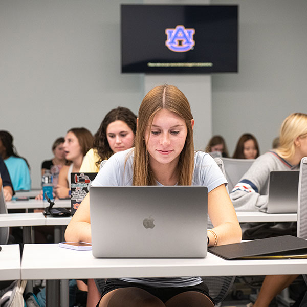 Student sitting at computer in classroom