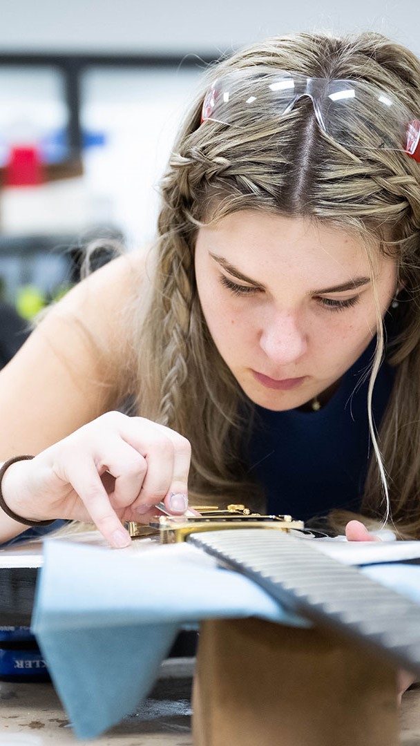 student working on guitar