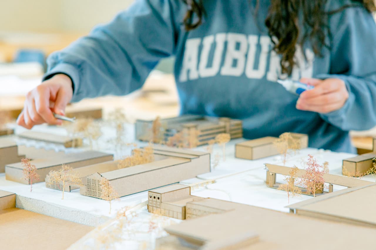 student working with a building model