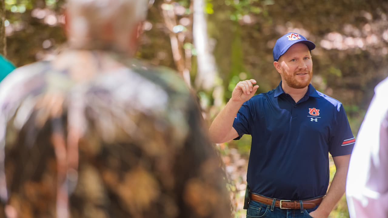 Extension educator teaching in a forest setting