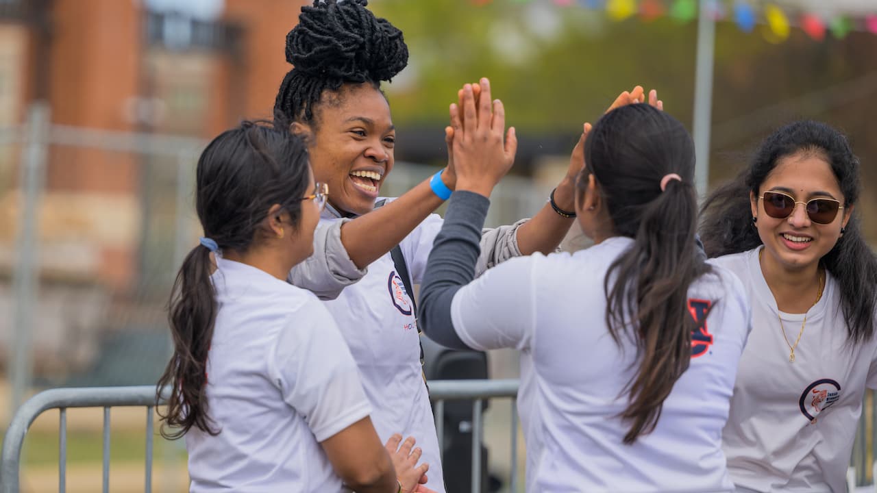 group of students high-fiving
