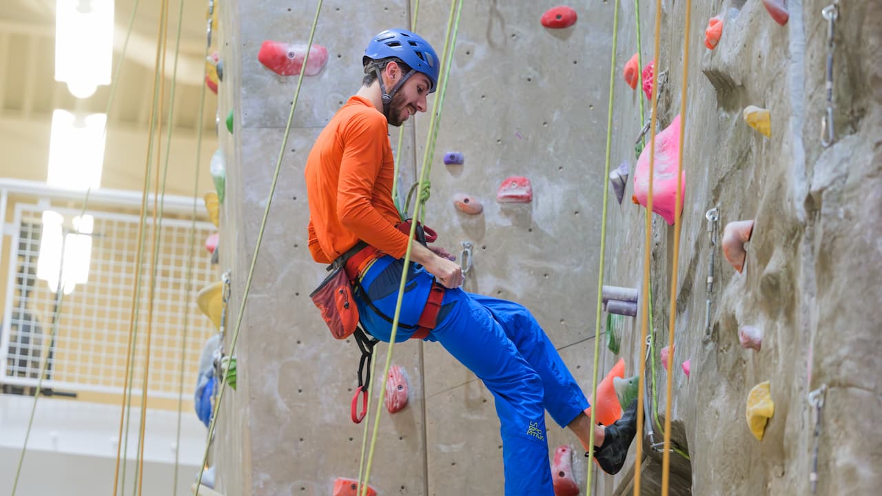 student on climbing wall