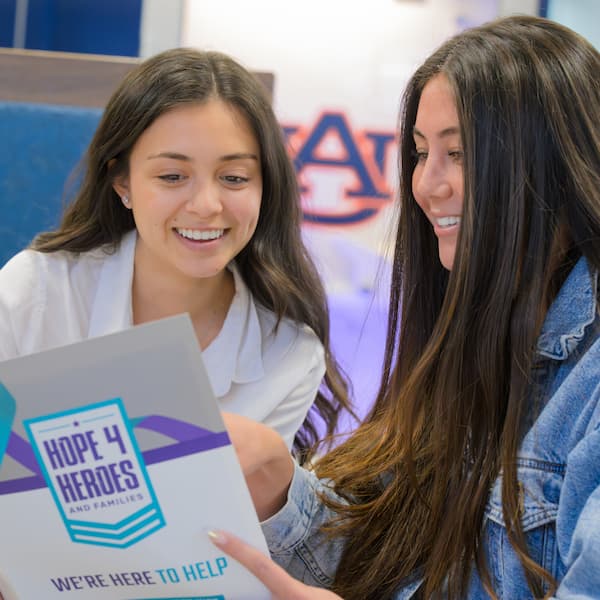 two women reading a brochure