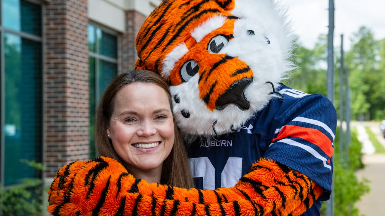 mascot hugging woman