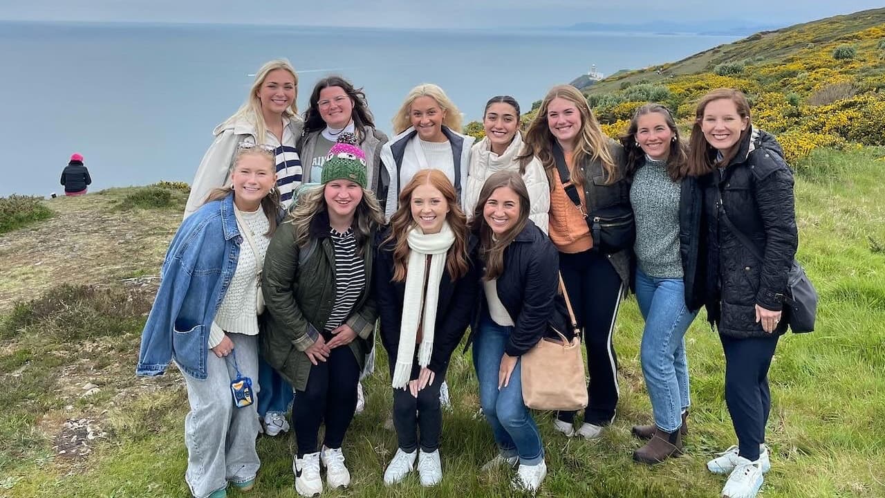 students in front of an ocean landscape