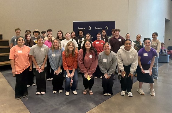 A large group of GEAR UP Achieve students pose for a photo in two long rows.