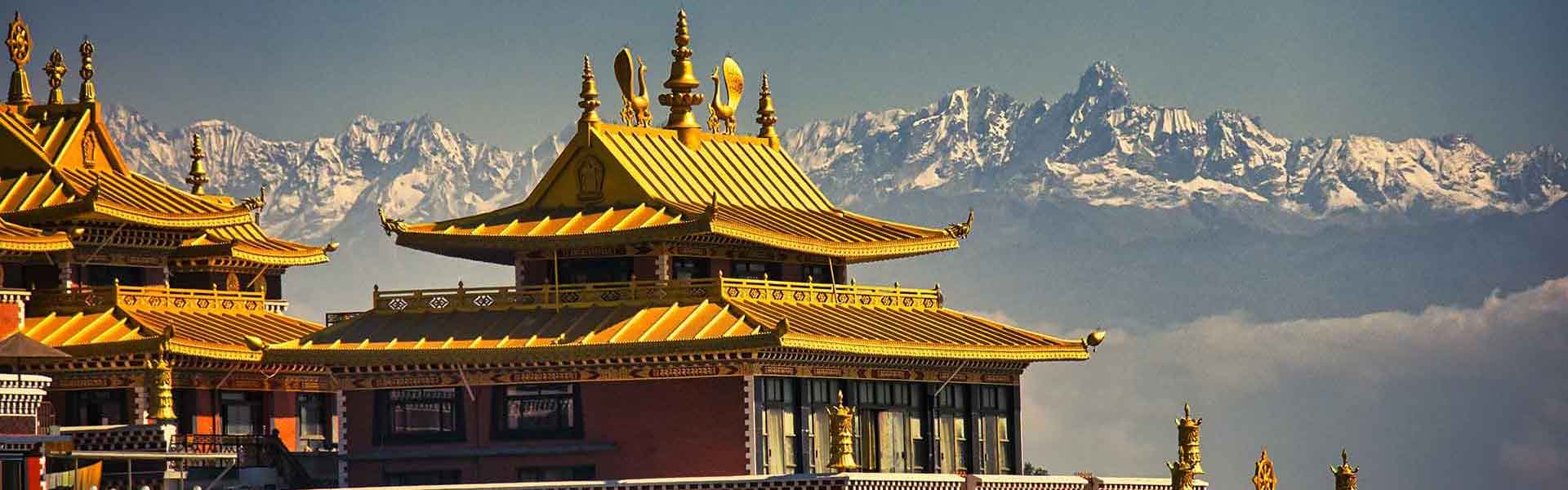 Buddhist temple in Nepal framed by the snow-covered peaks of the Himalayas.