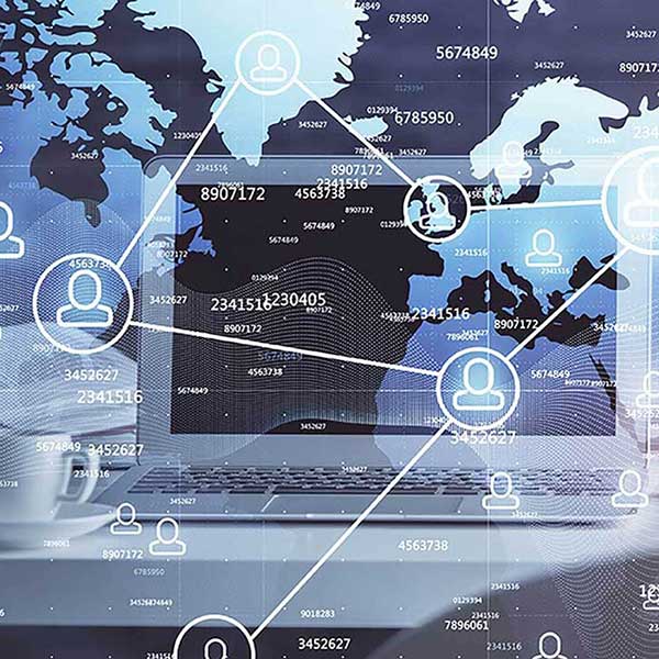 World map and connected user icons displayed over a laptop screen, representing global networking, digital communication, and international collaboration