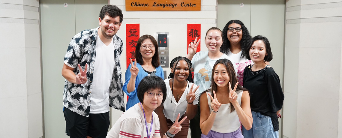 Students grouped under Chines Language Center Sign