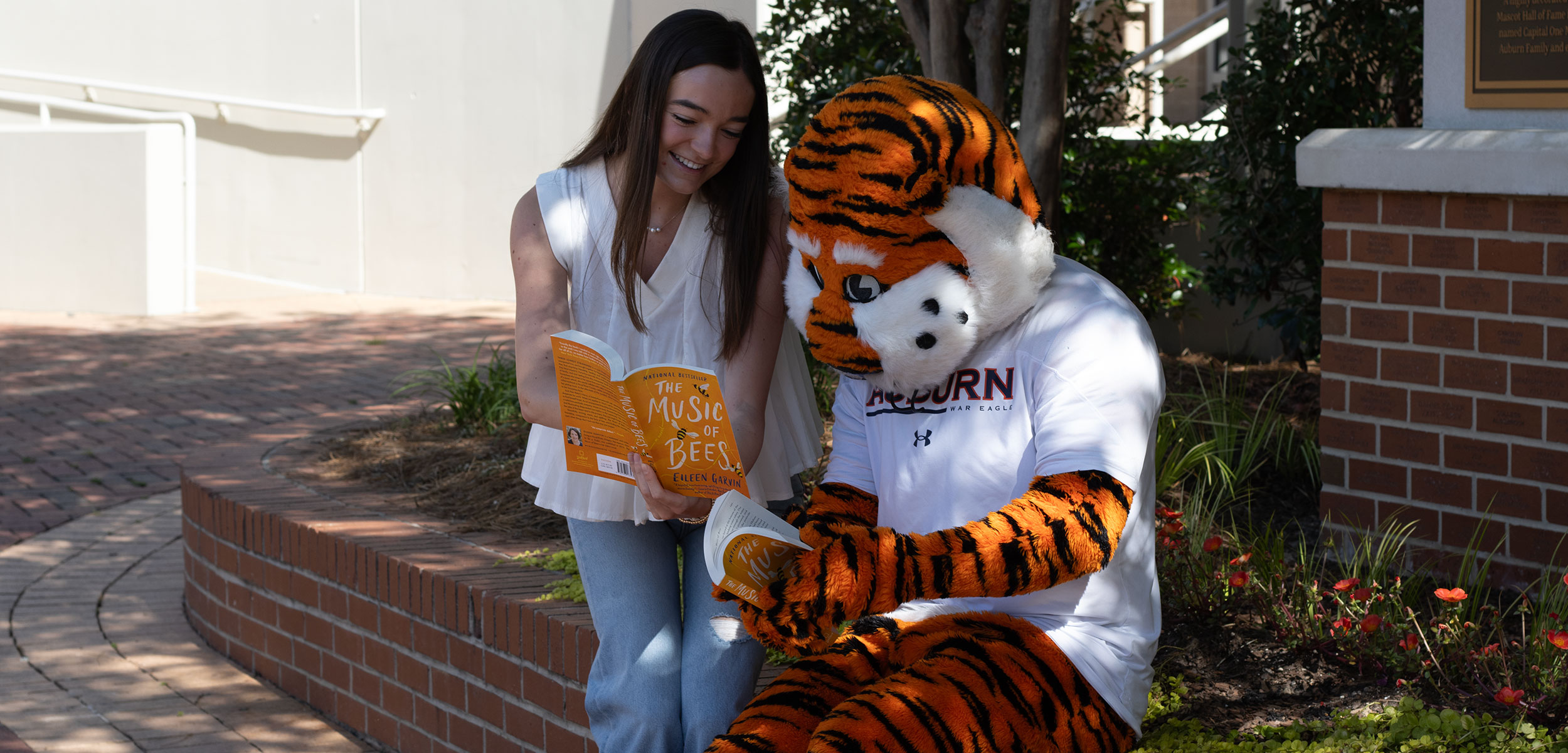 Aubie reading The Music of Bees with student