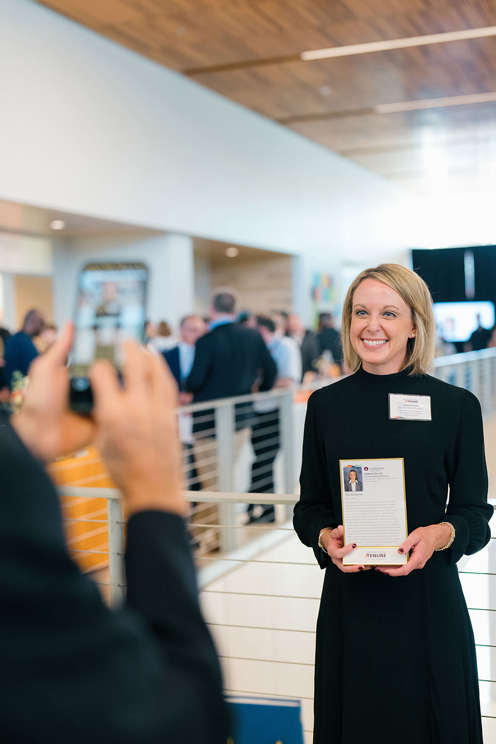 Promotion and Tenure 2025 recipient holding their bio plaque