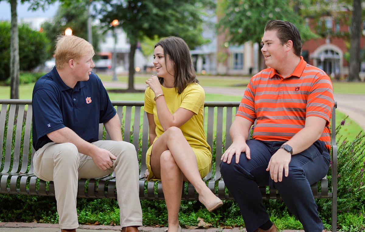 Students sit on a bench