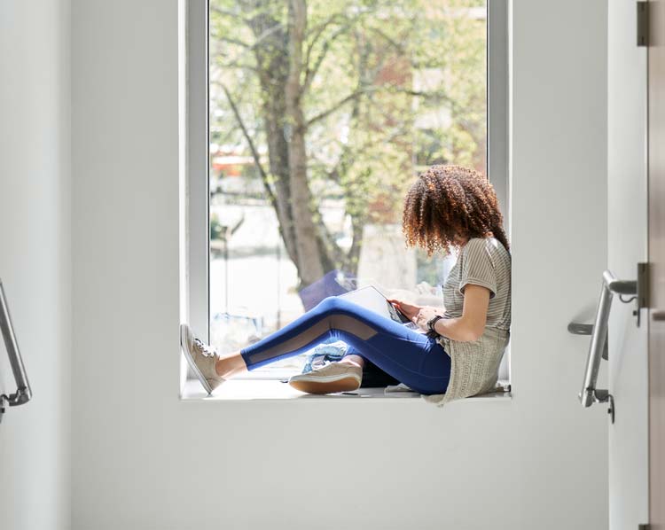 A student sits in a window seat