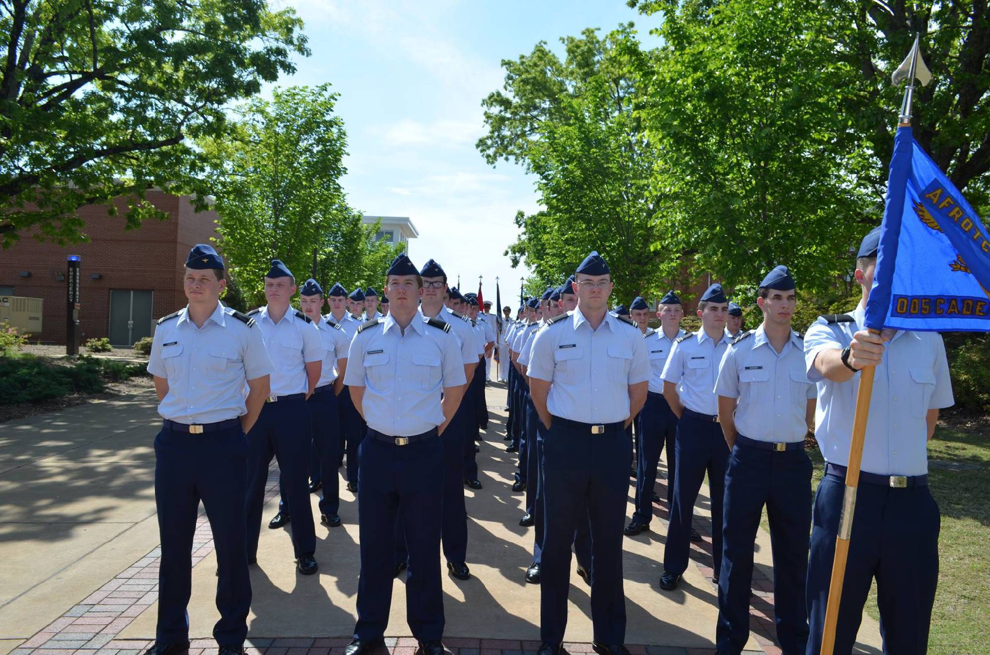AFROTC students in uniform with flag.