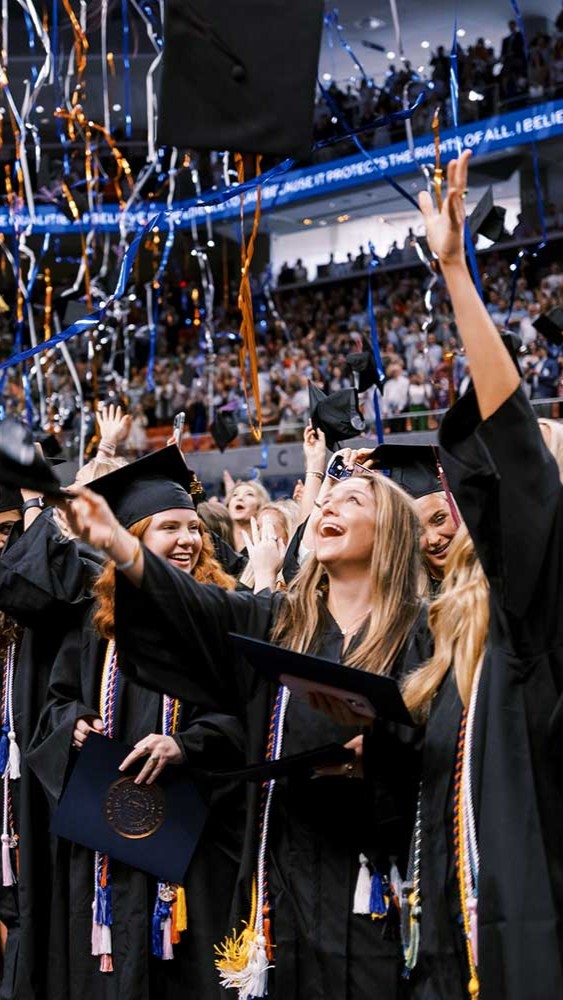 graduates celebrating under graduation streamers