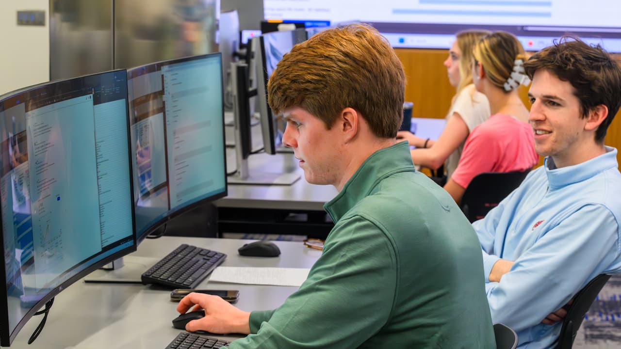 two students sitting at a computer