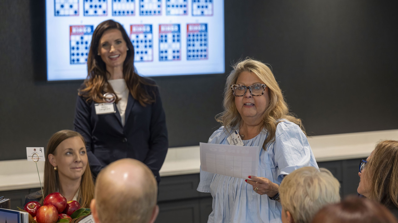 two employees presenting to a group of people
