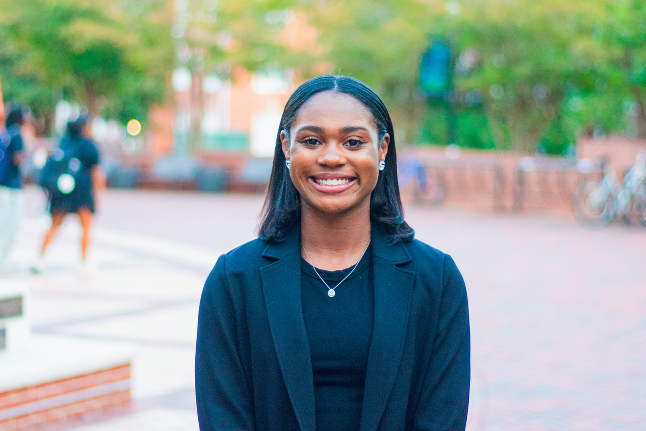 A photo of a student who participated in Tiger Takeoff standing outside on campus smiling for the camera.