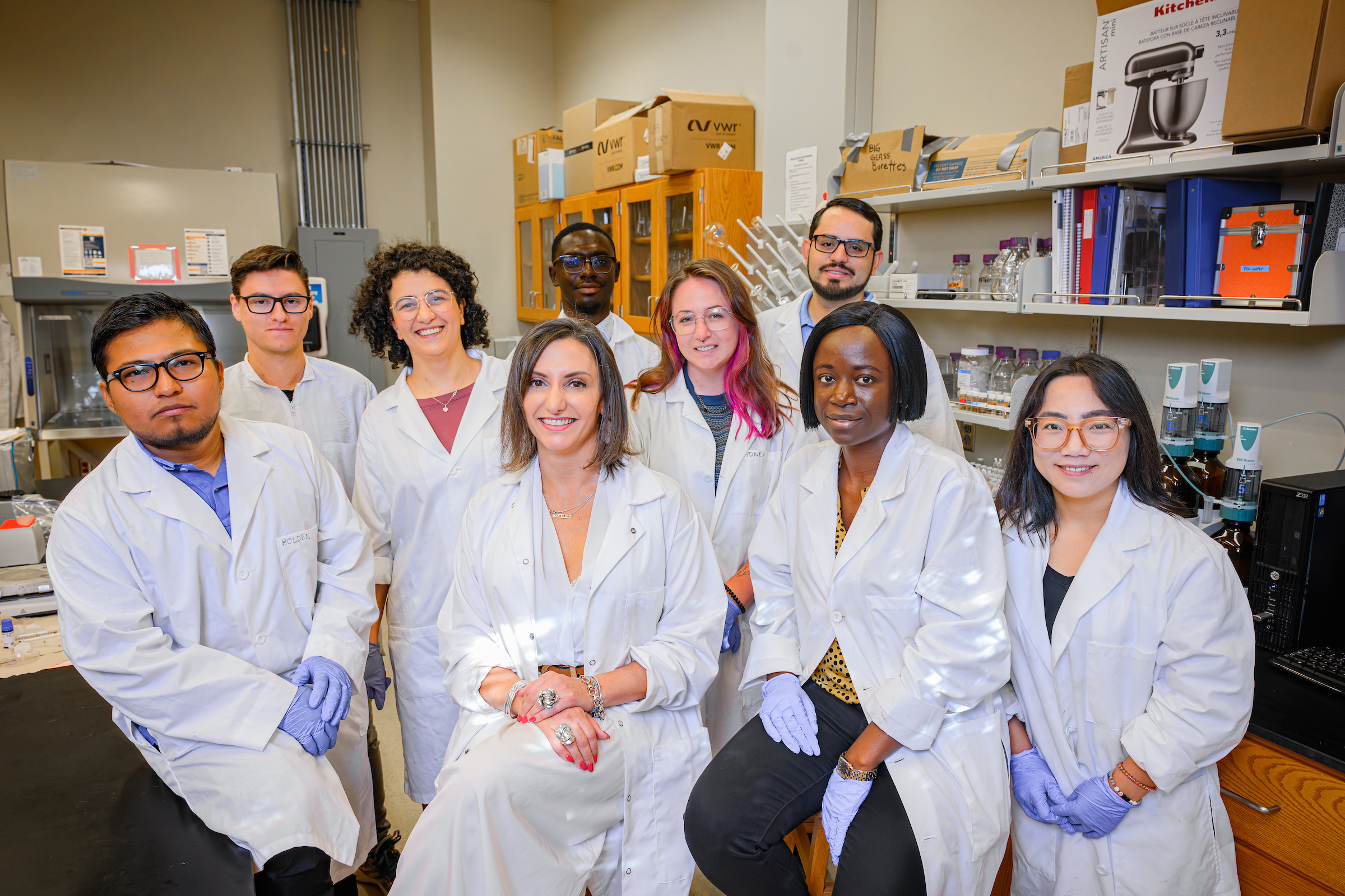 Several individuals posing in a laboratory