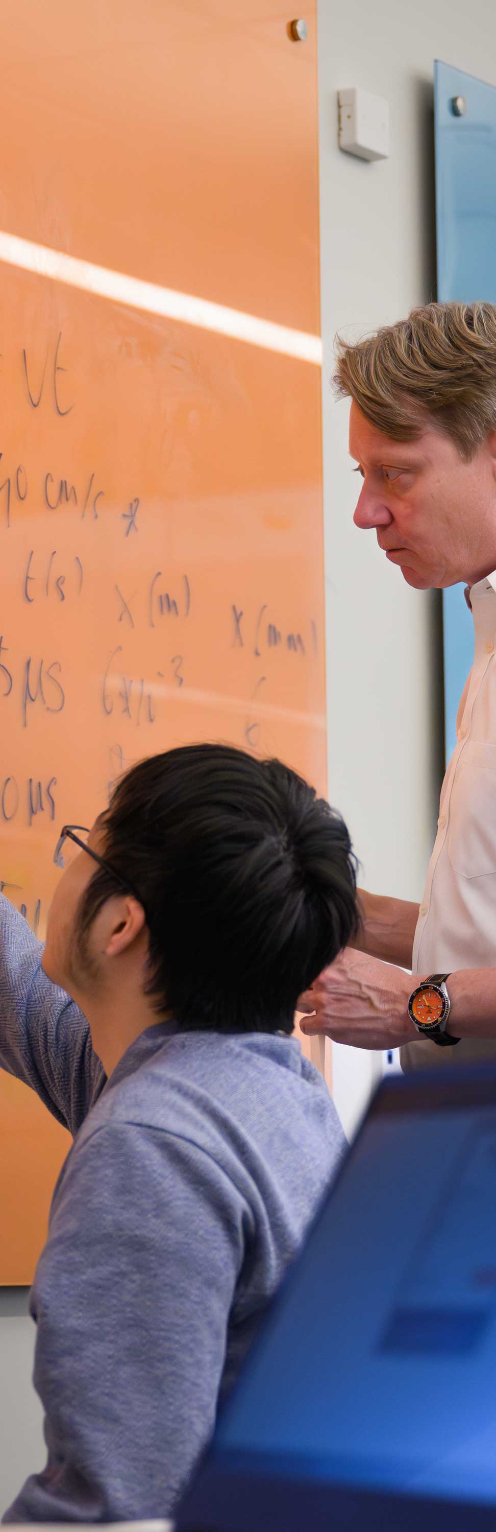 Photograph of professor and student working together in classroom