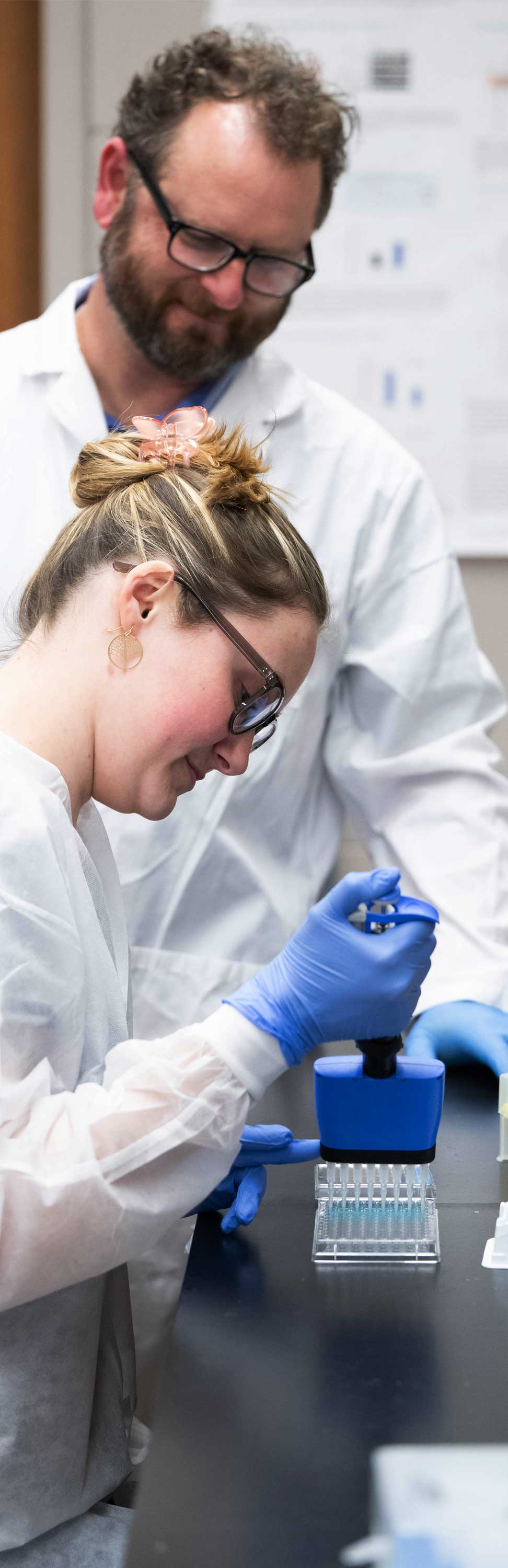 Photograph of instructor and student conducting lab research