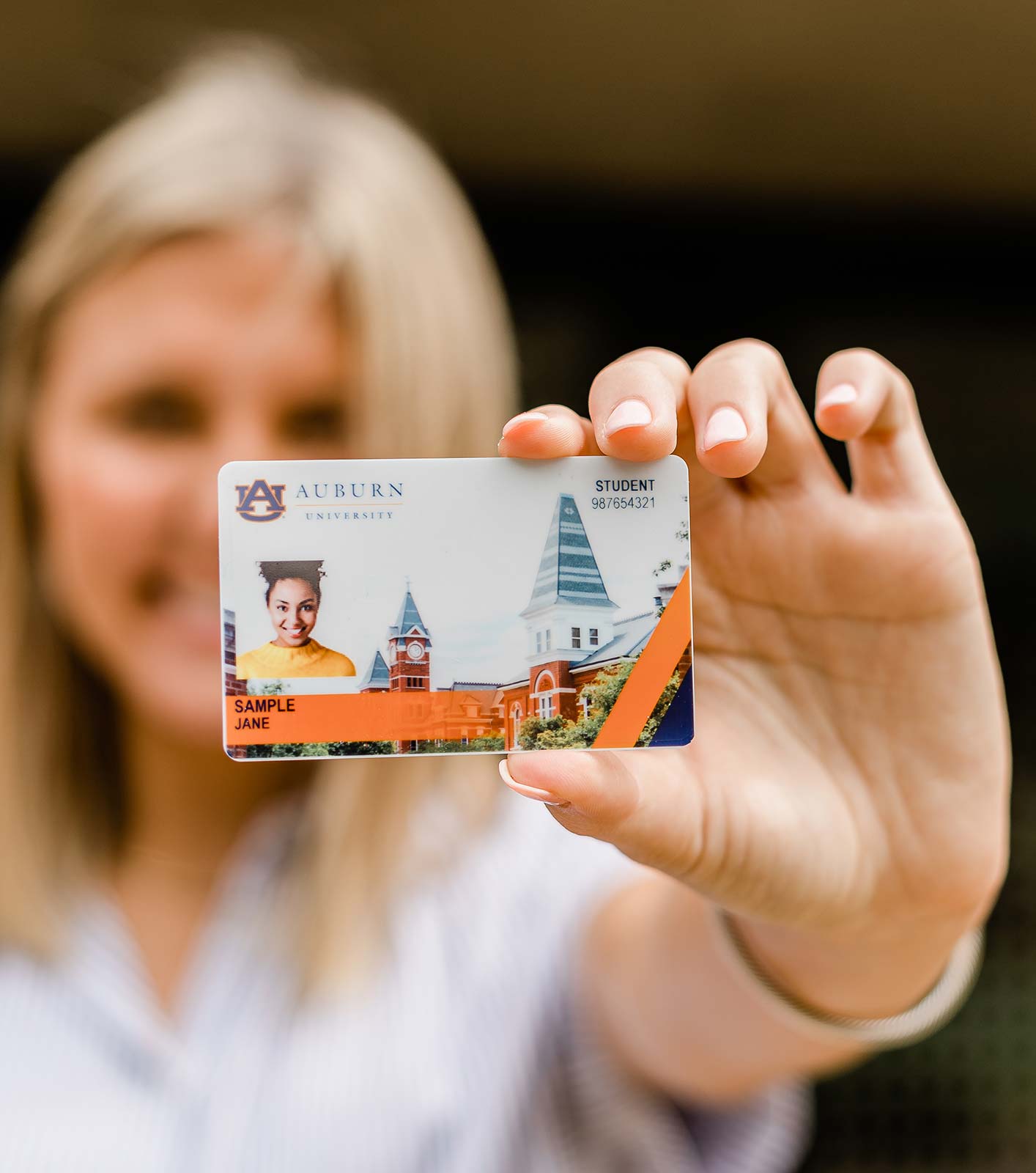 A student holds a sample Tiger Card ID