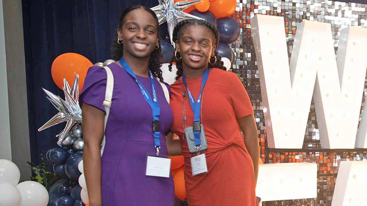 Two ladies pose at a Tiger Takeoff event