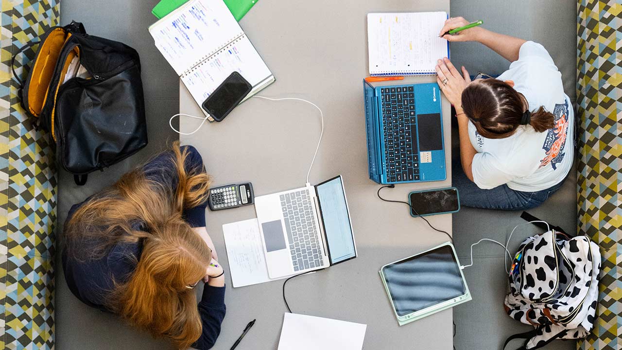 Two people at a desk working