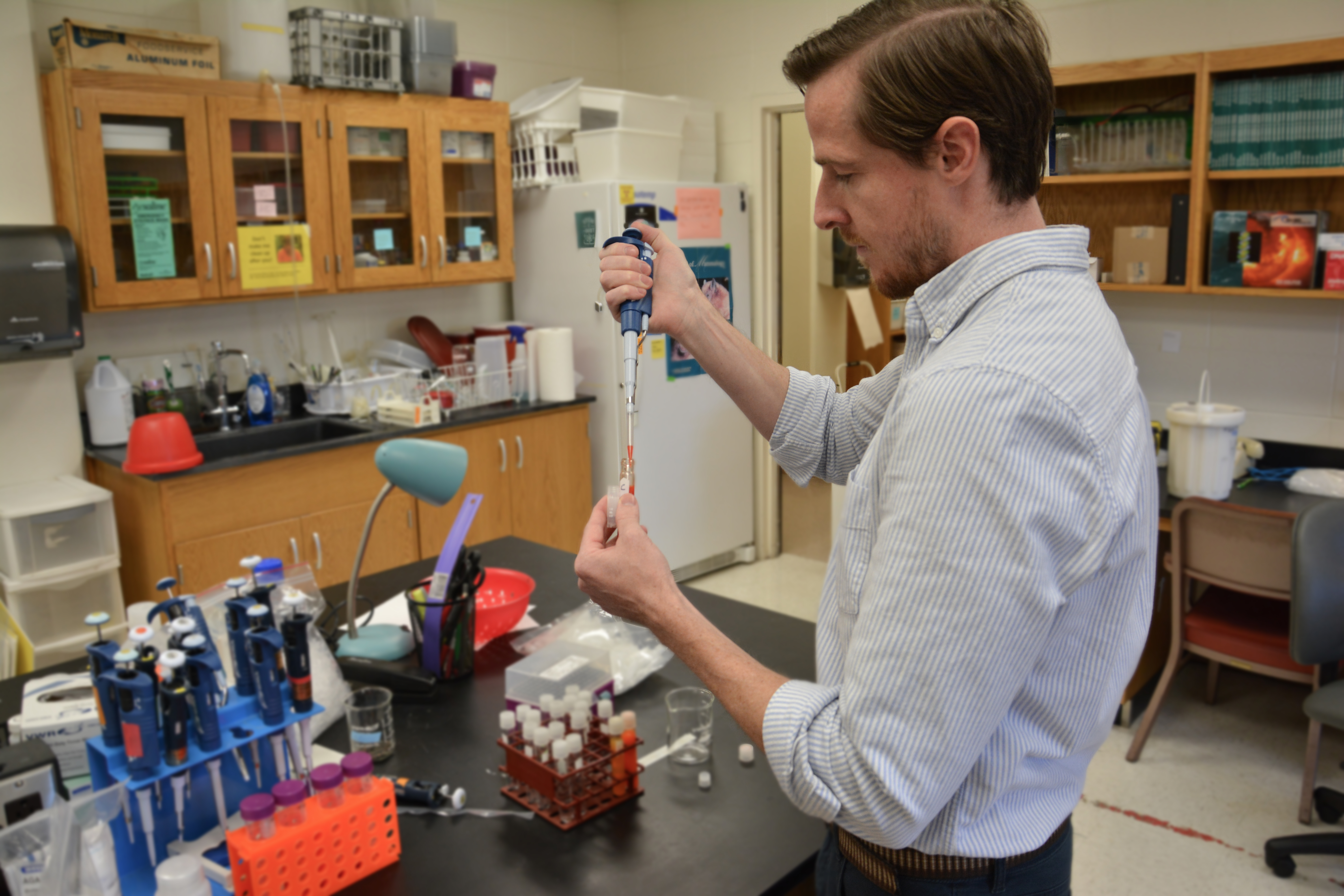 Ryan Weaver using a pipette in the lab