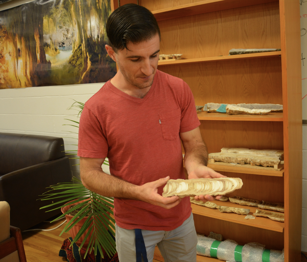 Dr. Matthew DeCesare, lab manager, holding one of many stalagmites collected.