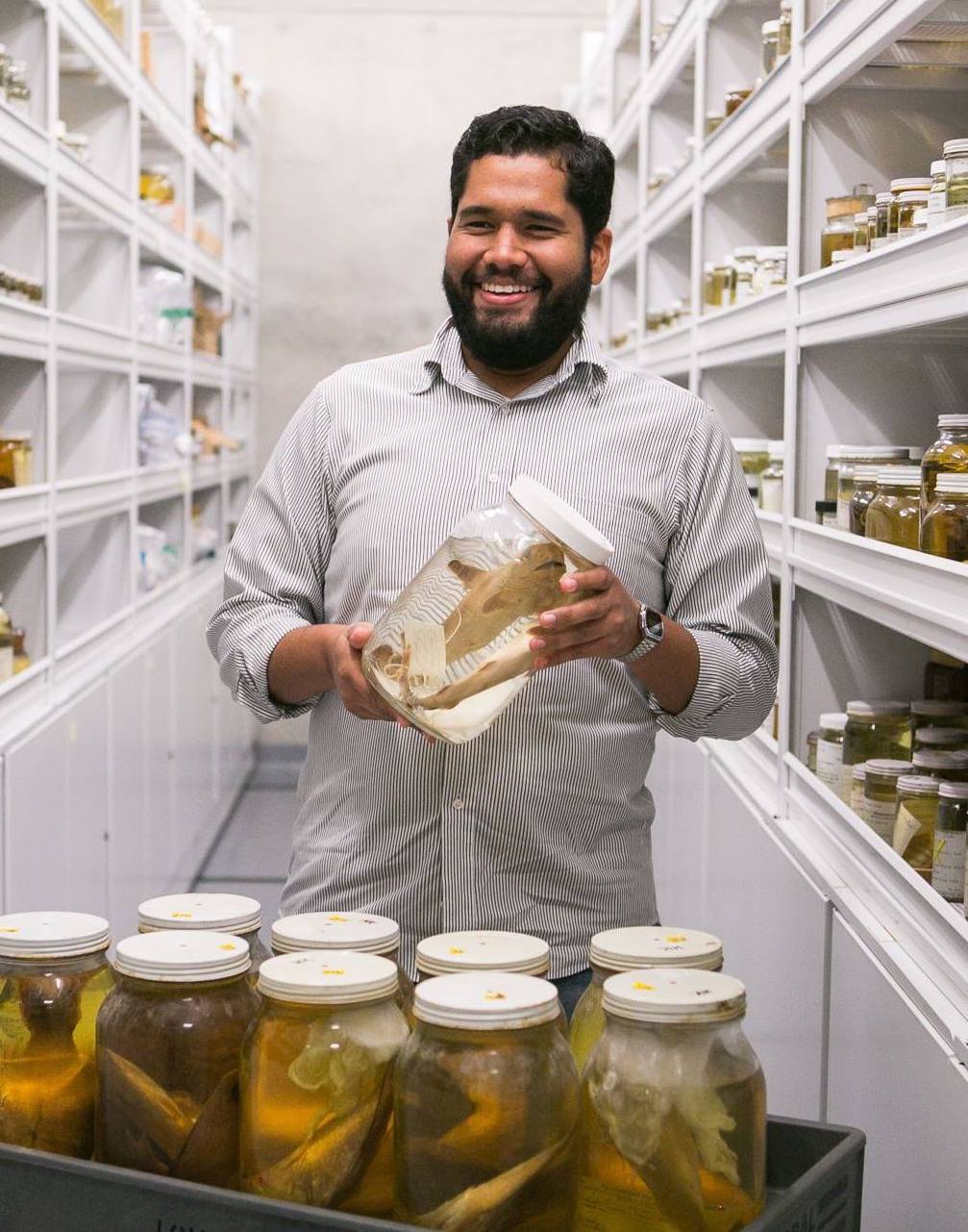Bernal holding specimens in the Department of Biological Sciences. 