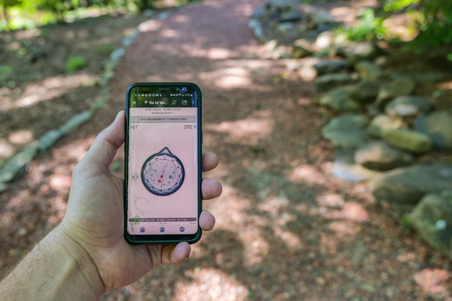navigating to a geocache using an app with compass on a smartphone