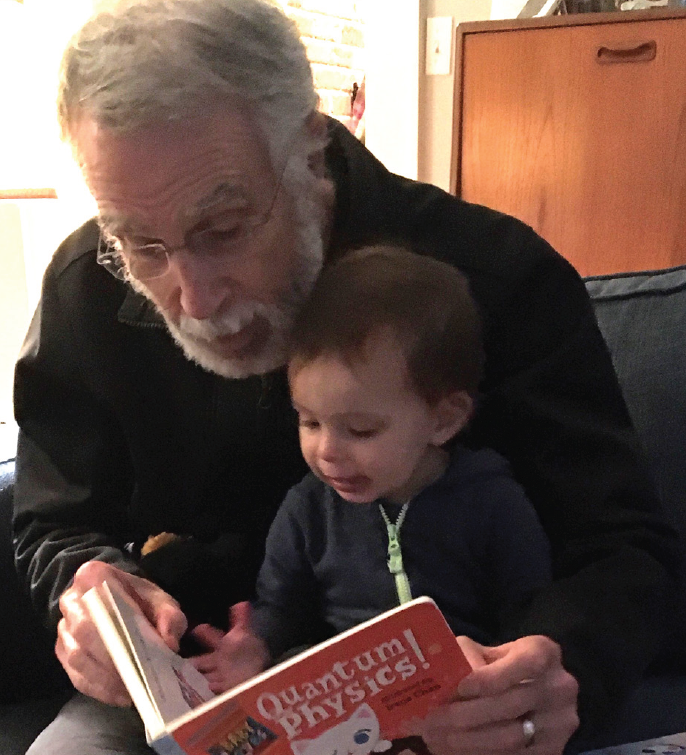 COSAM Dean Giordano reading to his granddaughter.