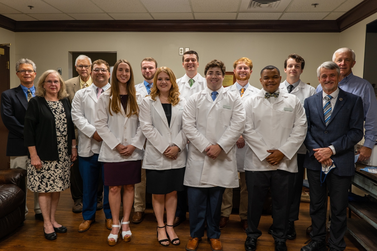 Dr. Keith Bufford, Dr. Lanita Carter and Dr. Larry Wit are pictured to the left of the students. Dr. Golden from EAMC (back row) and Dr. Robert Boyd (front) are pictured to the right of the students.