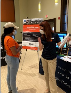 Katie Brown speaking with a student at the FAMU Graduate School Recruitment Fair.