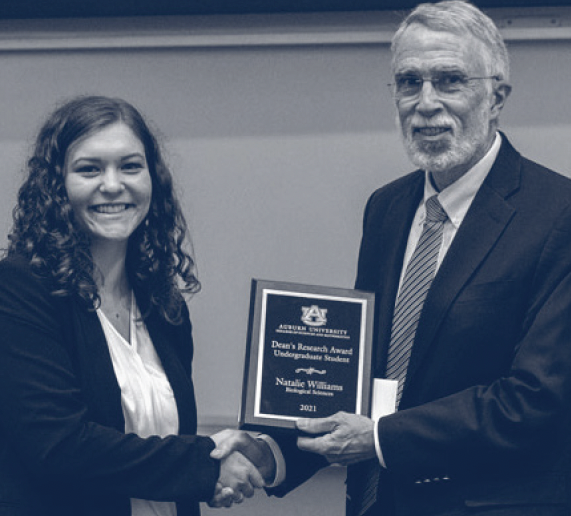 Natalie accepts the Dean's Research Award from former Dean Nicholas Giordano.