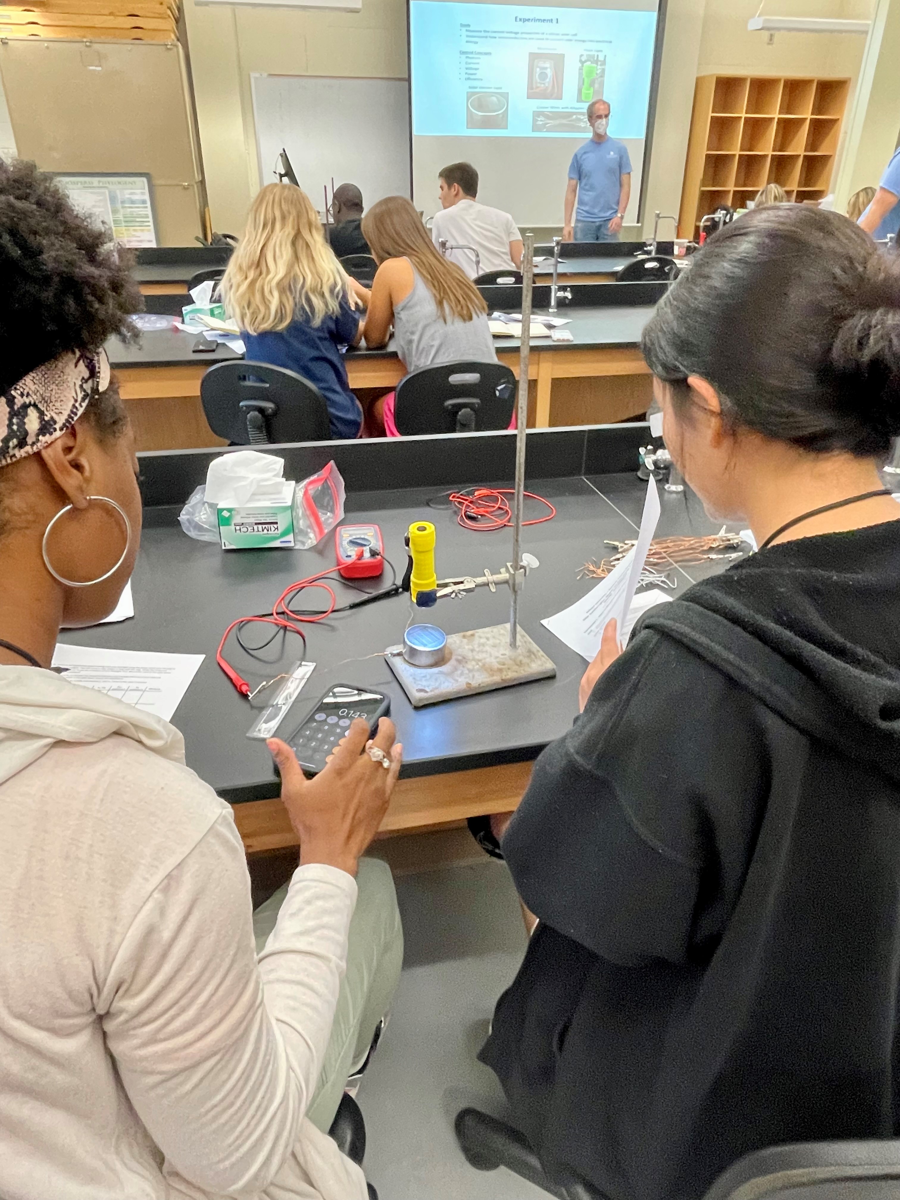 Summer Science Institute students Serenity Griffin and Dani Kim work together to measure current-voltage properties of a silicon solar cell to understand how semiconductors are used to convert solar energy into electrical energy.