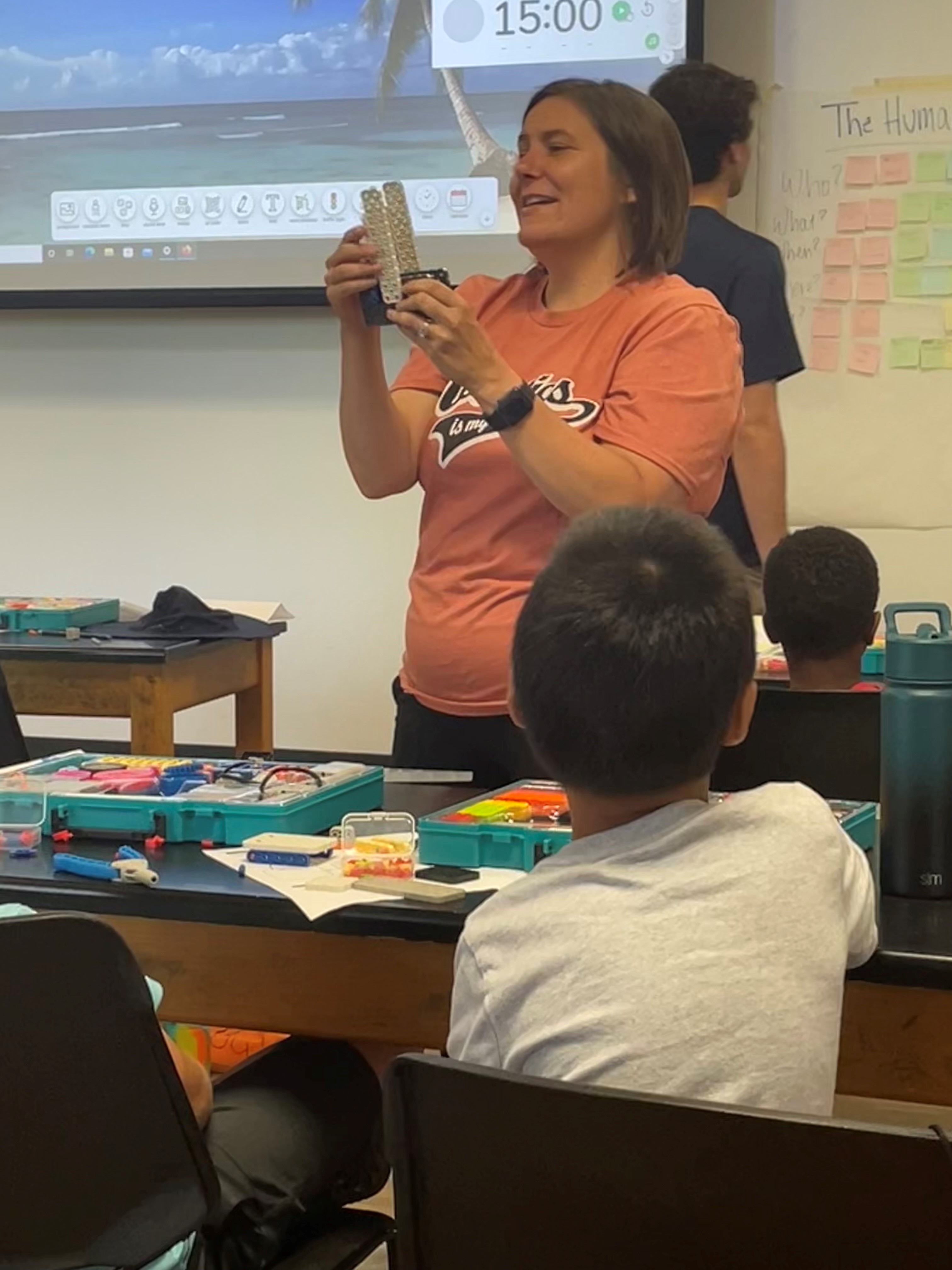 Lead VEX GO instructor Tina Williams, an educator at Yarbrough Elementary School, discusses ways to improve the robotics spaceship at VEX GO camp.