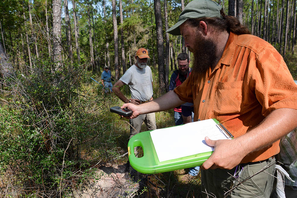Jimmy Stiles marks the location for a snake release on a GPS