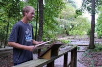 Student interacting with a storm water tour display