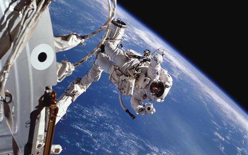 An astronaut performs a space walk