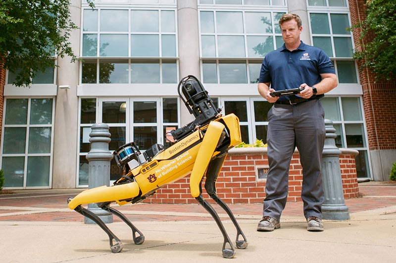 A man controls a robotic dog.