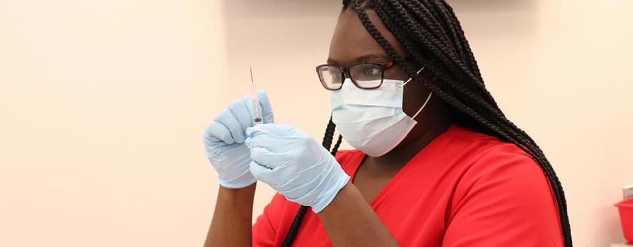 A student examines a syringe.